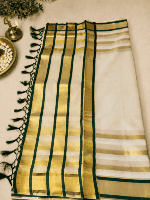 A timeless cream and gold tissue  saree with rich dark green detailing