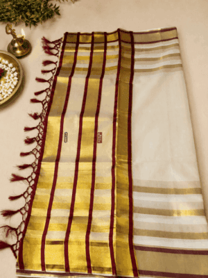 A graceful cream, gold and maroon tissue saree
