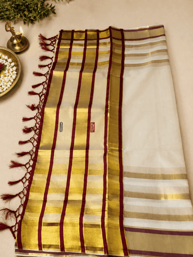 cropped-file_00000000d000820b842a31bacc28d627.png A graceful cream, gold and maroon tissue saree - Image 1