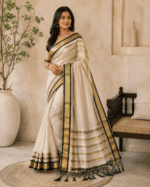 A timeless cream and gold tissue  saree with rich dark green detailing - Image 2